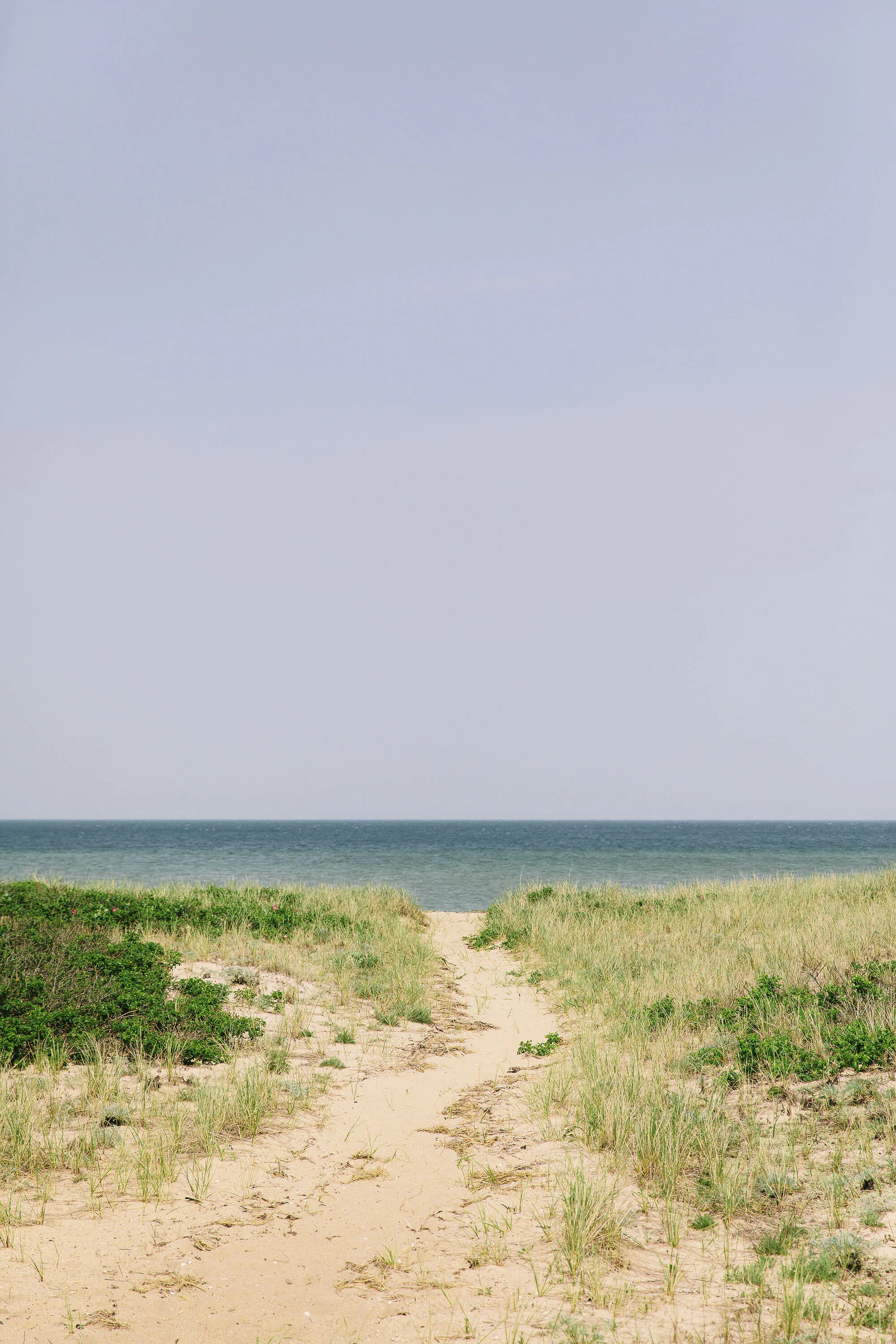 Sandy beach path through dunes toward the Atlantic — walkable Island access without a car