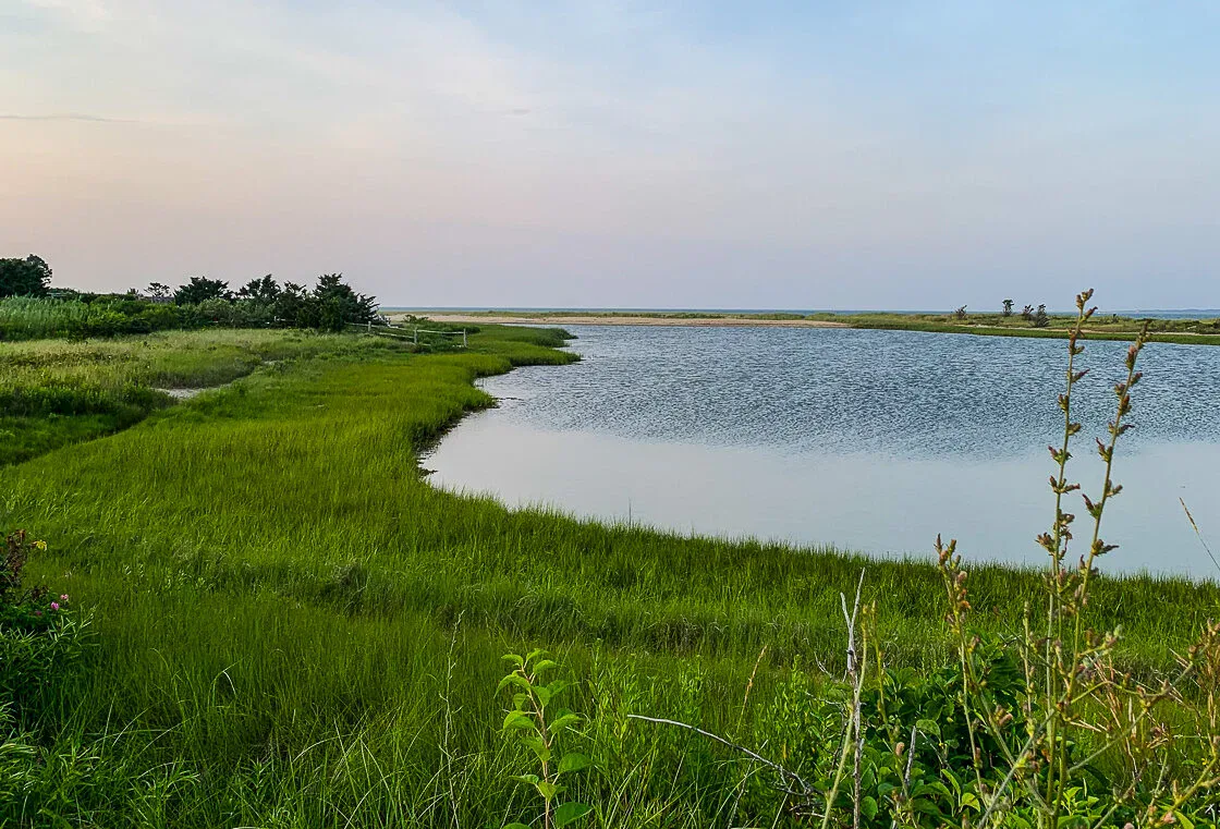 Quiet Edgartown marsh and pond at dusk, unhurried longer-weekend mood